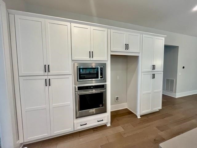 2626 Salient Apex, NC 27523 - Photo 19 of 52 a kitchen with white cabinets and refrigerator