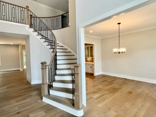 2626 Salient Apex, NC 27523 - Photo 5 of 52 a view of a hallway with wooden floor and stairs