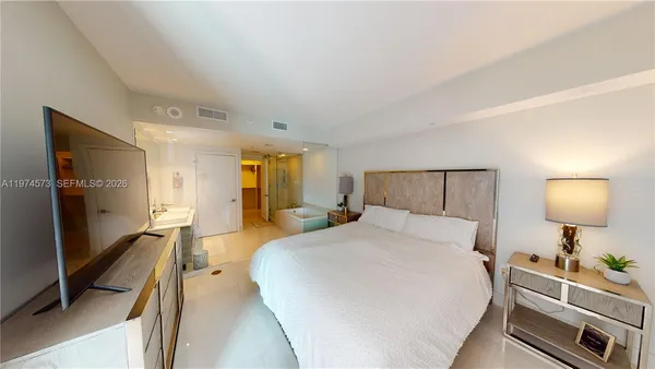 a bedroom with a bed and a lamp on table