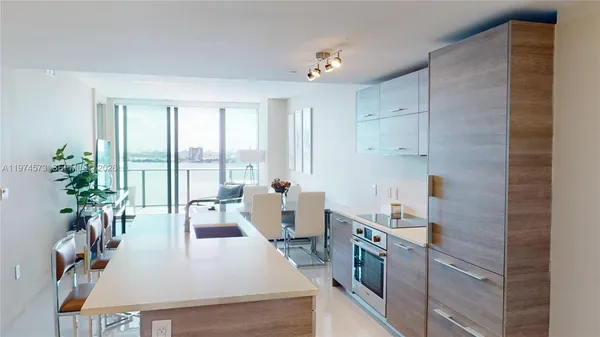 a large kitchen with sink a refrigerator and a stove