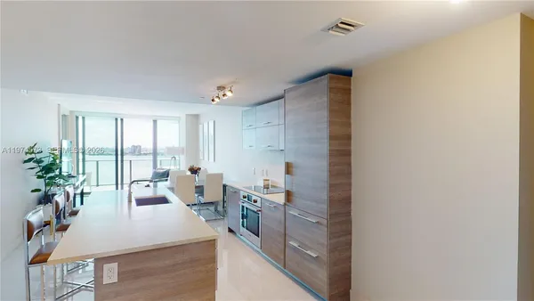 a large room with a large window and furniture
