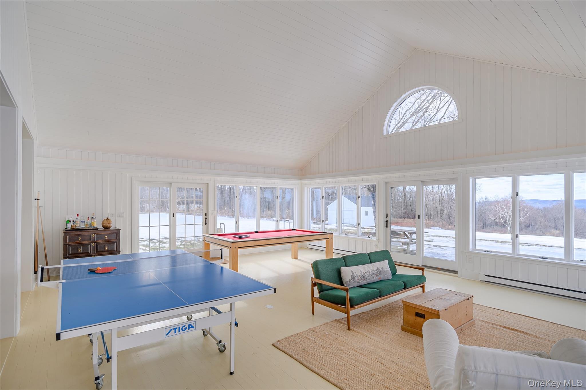 159 Old Quaker Hill Road Pawling, NY 12564 - Photo 13 of 40 Recreation room with plenty of natural light, high vaulted ceiling, a baseboard radiator, wood walls, and billiards table