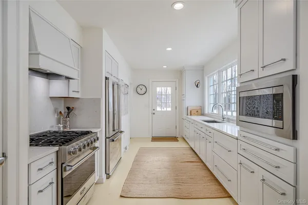 a large kitchen with a stove and cabinets