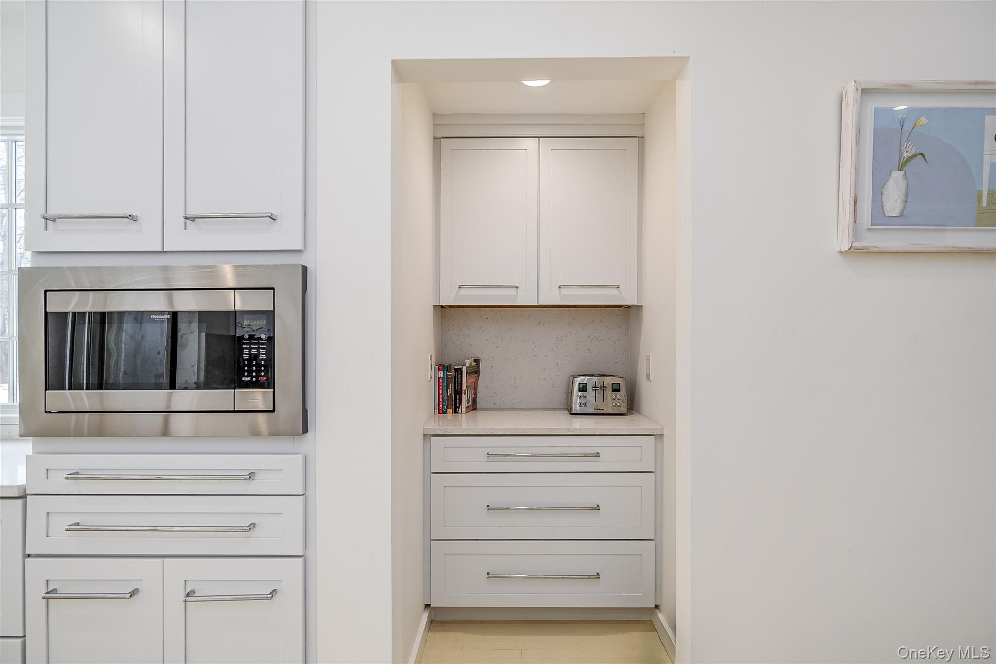 159 Old Quaker Hill Road Pawling, NY 12564 - Photo 17 of 40 Kitchen view of stainless steel microwave, light stone counters, and white cabinetry