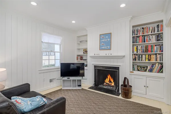 a living room with furniture a rug and a fireplace