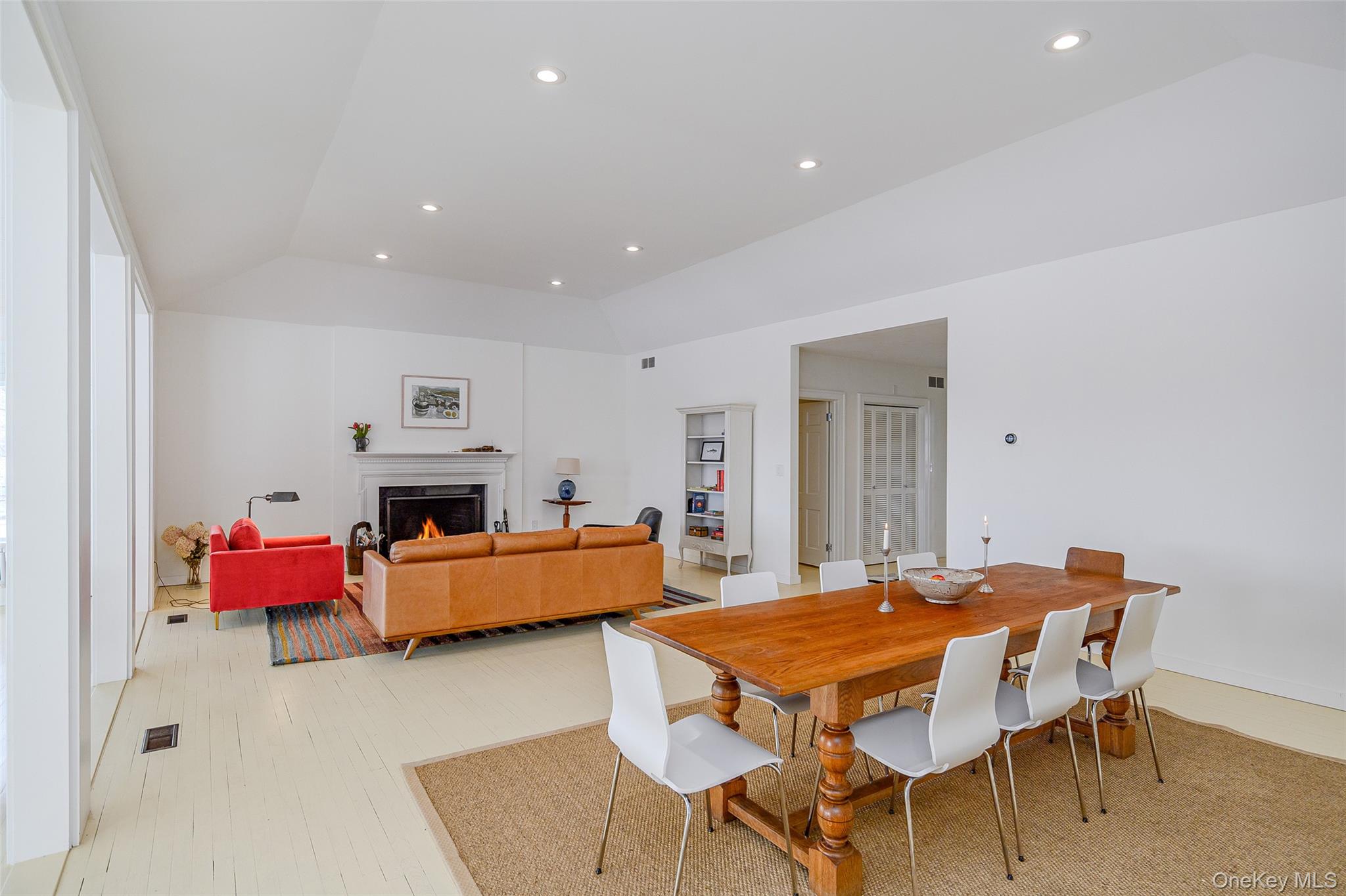 159 Old Quaker Hill Road Pawling, NY 12564 - Photo 10 of 40 Dining area featuring a lit fireplace, recessed lighting, lofted ceiling, and light wood-style floors