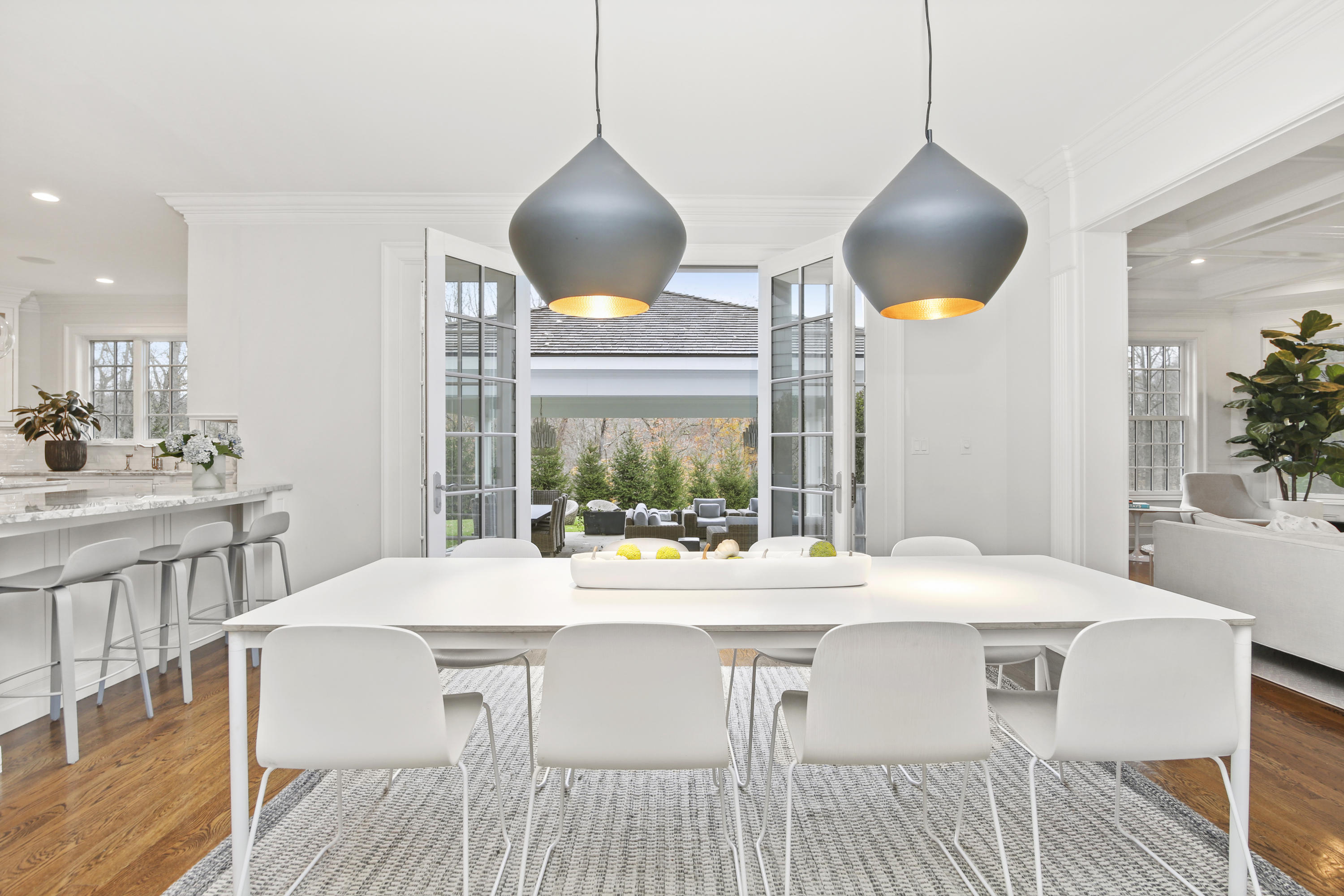 121 Chichester Road New Canaan, CT 06840 - Photo 13 of 42 a kitchen with a table chairs and a chandelier