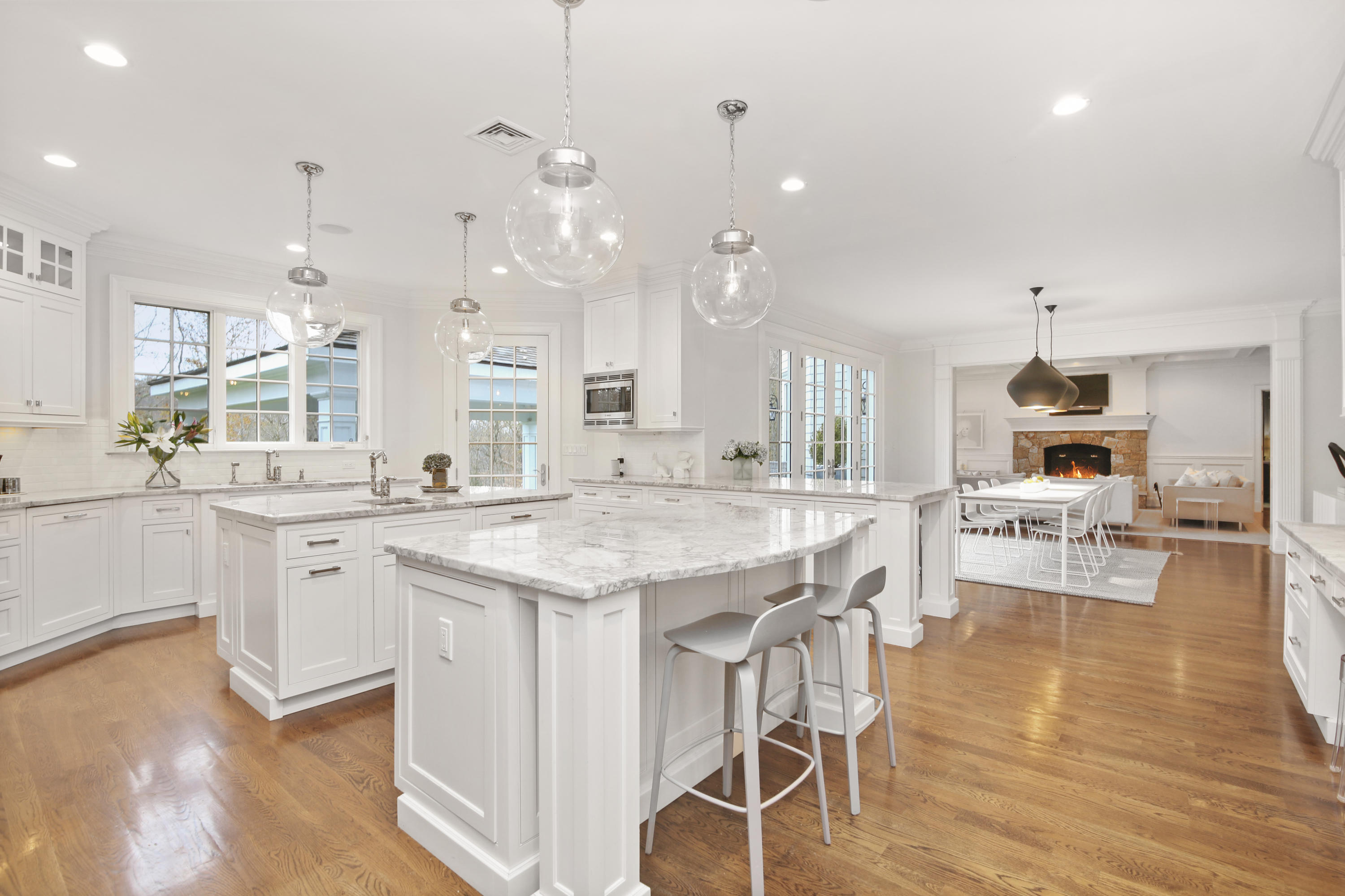 121 Chichester Road New Canaan, CT 06840 - Photo 16 of 42 a large kitchen with cabinets chairs and wooden floor