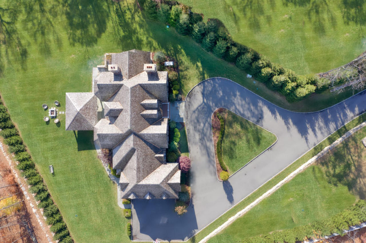 121 Chichester Road New Canaan, CT 06840 - Photo 2 of 42 an aerial view of a house with a garden and lake view