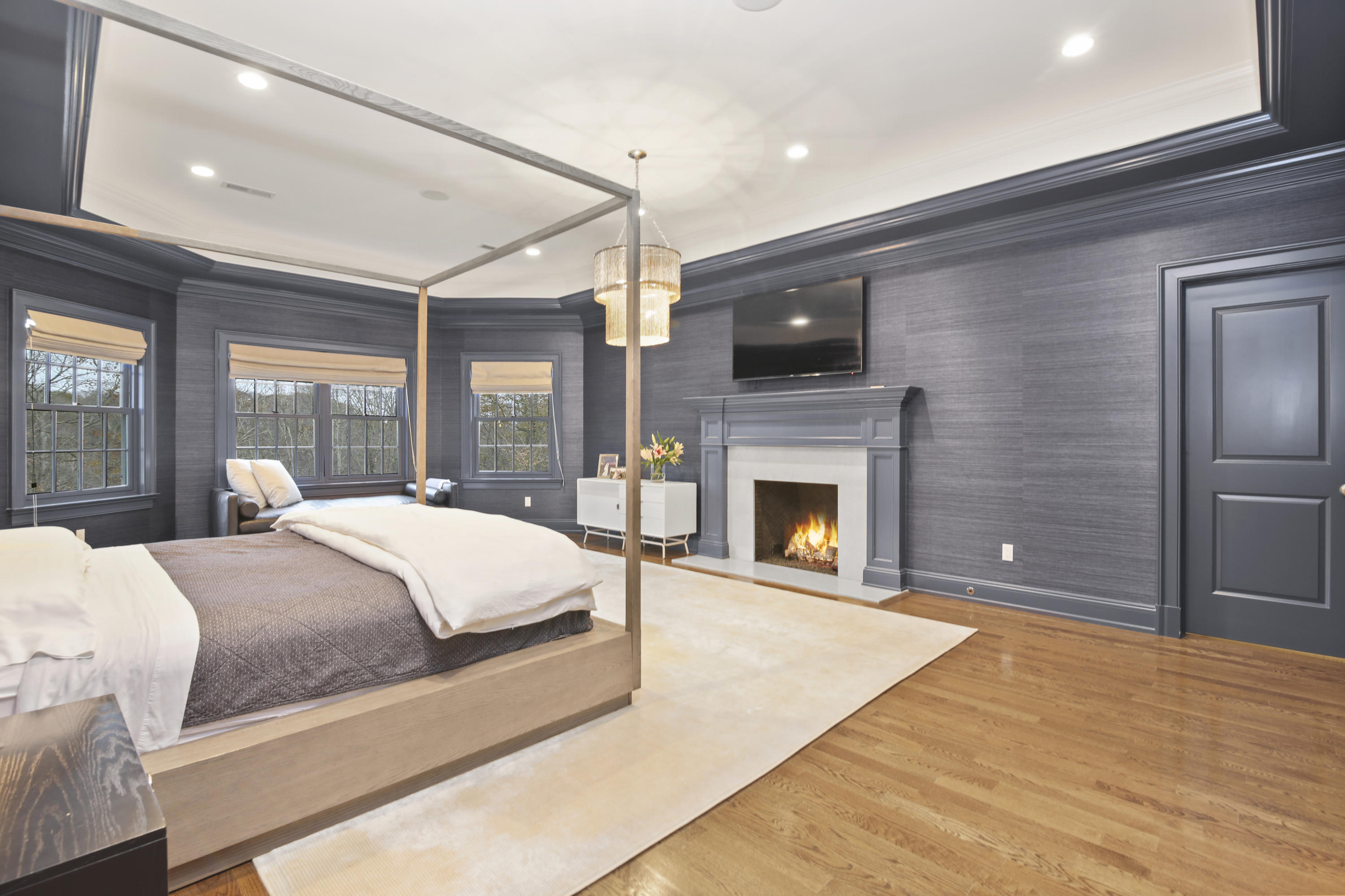 121 Chichester Road New Canaan, CT 06840 - Photo 22 of 42 a spacious bedroom with a bed and a fireplace