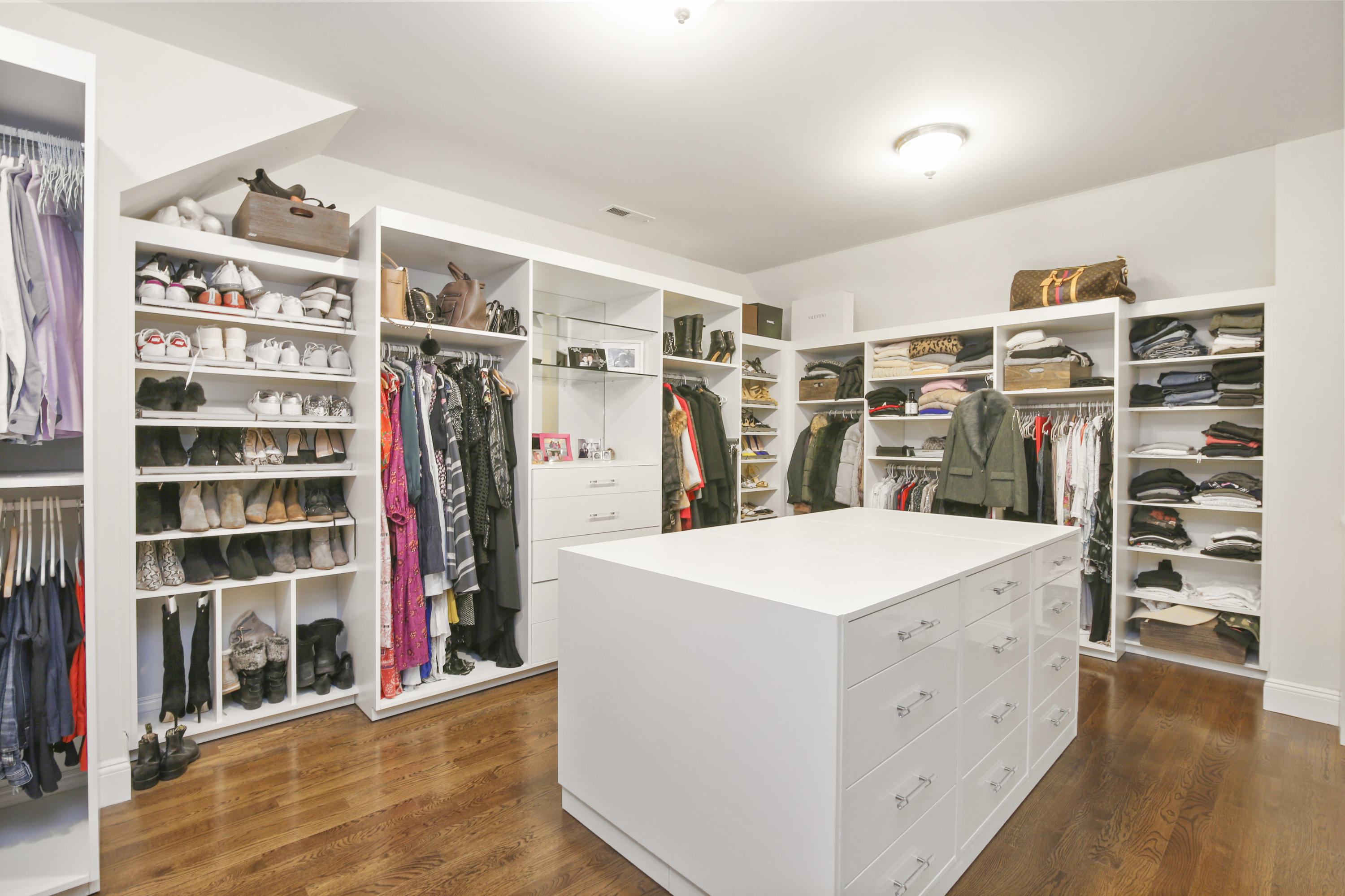 121 Chichester Road New Canaan, CT 06840 - Photo 24 of 42 a view of walk in closet with clothes and shoes
