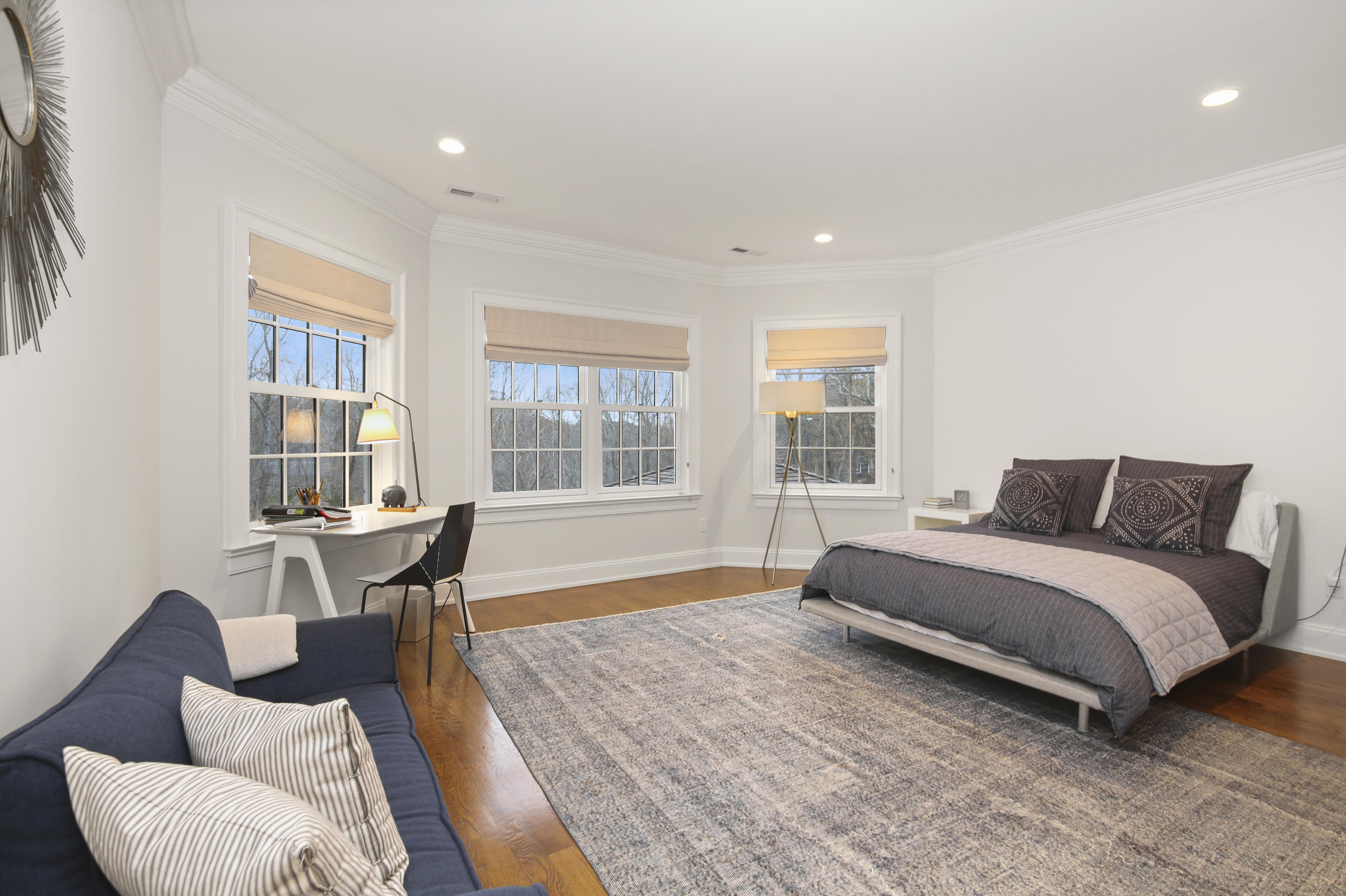 121 Chichester Road New Canaan, CT 06840 - Photo 28 of 42 a spacious bedroom with a bed and a table in it