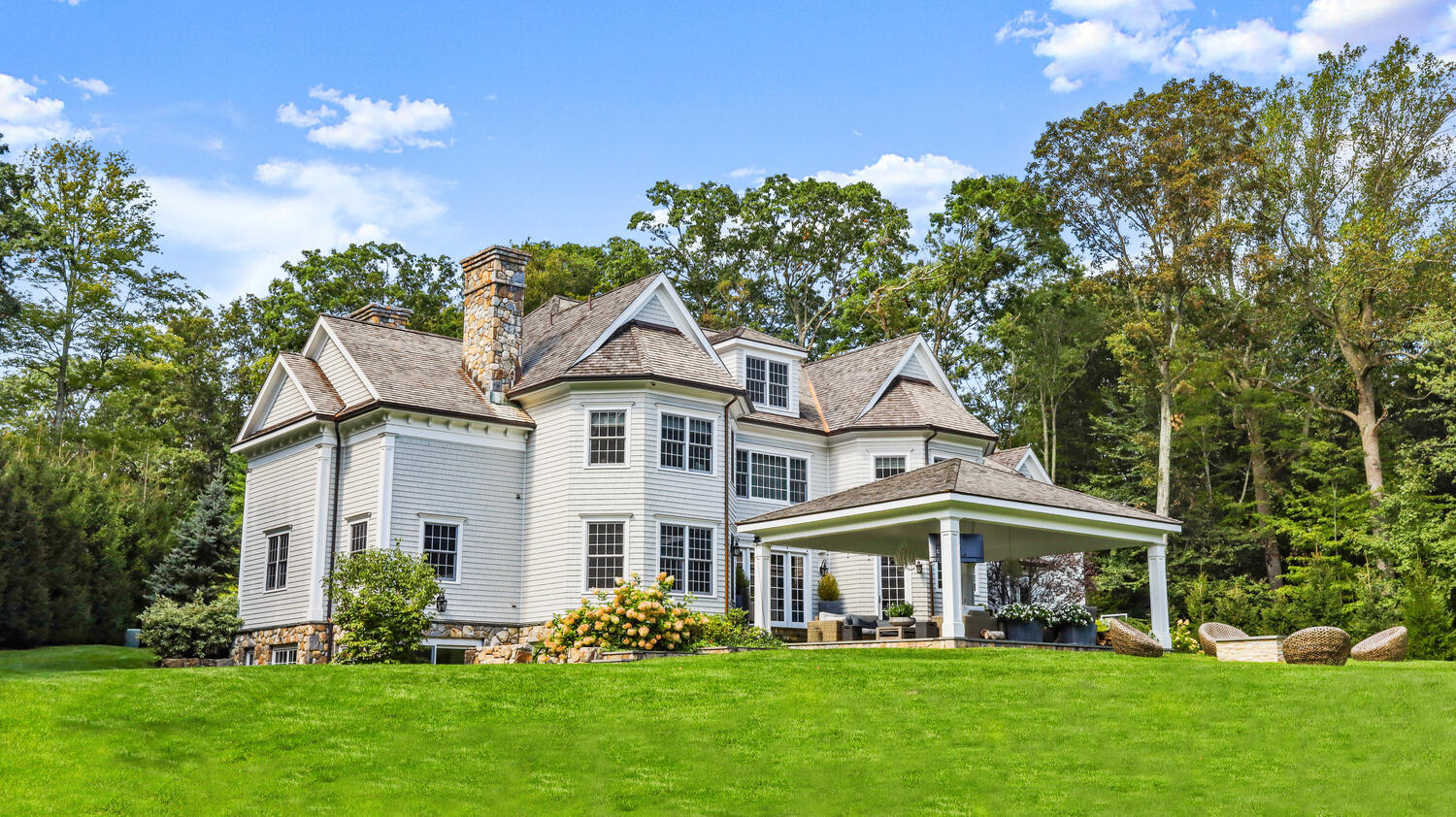 121 Chichester Road New Canaan, CT 06840 - Photo 3 of 42 a front view of a house with garden