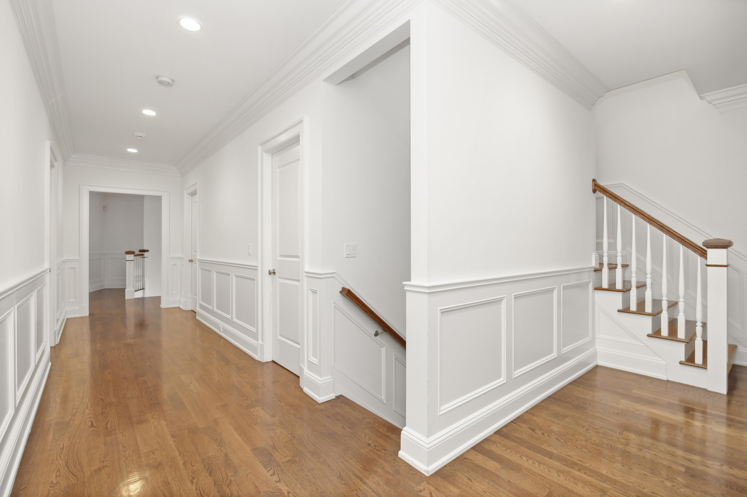 121 Chichester Road New Canaan, CT 06840 - Photo 31 of 42 a view of a hallway with wooden floor and stairs