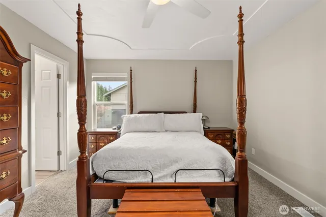 a bedroom with a bed mirror and a window