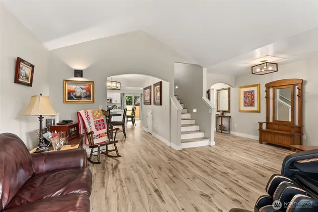 a living room with furniture and wooden floor