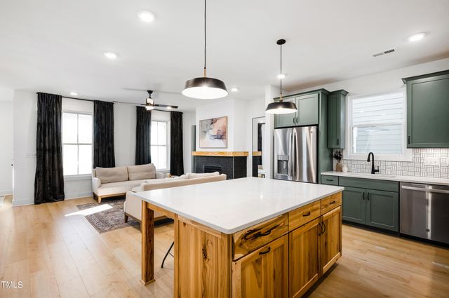 a living room with furniture a flat screen tv and a large window
