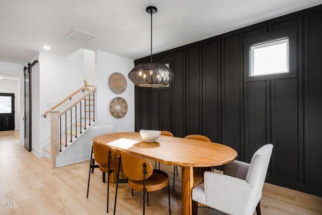 a living room with furniture a fireplace and kitchen view