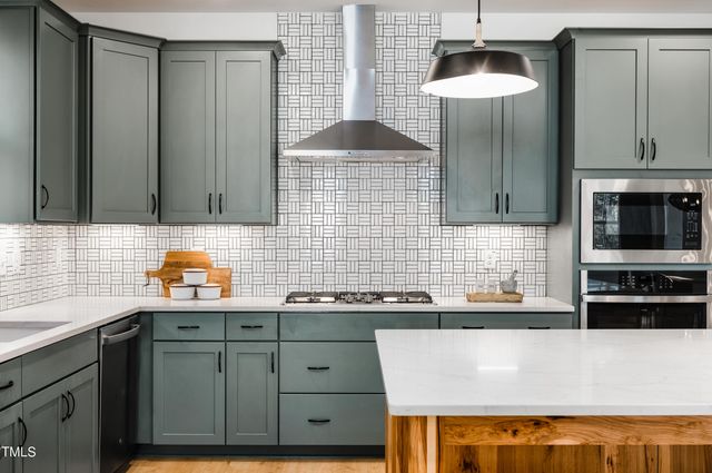 a dining room with furniture a chandelier and wooden floor