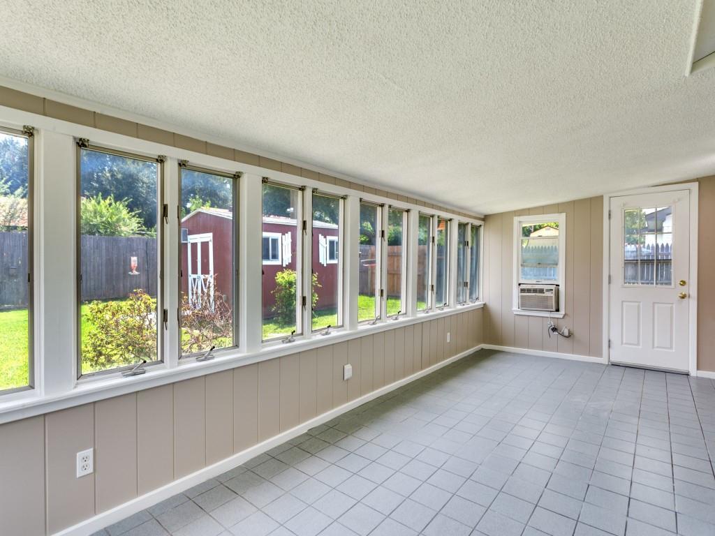1216 Manning Street Benbrook, TX 76126 - Photo 20 of 26 Unfurnished sunroom with a textured ceiling, tile patterned flooring, and vaulted ceiling