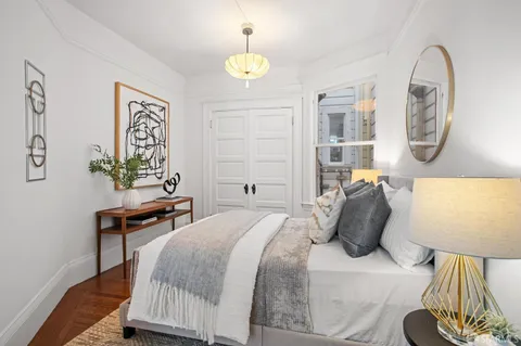 a bedroom with a bed and a lamp