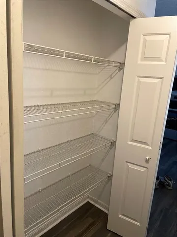 a view of walk in closet with empty racks