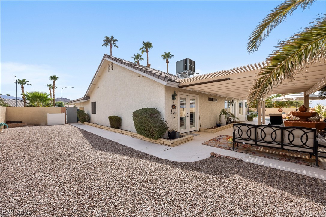 814 Manor Shores Road Henderson, NV 89002 - Photo 26 of 40 Palm trees surround this low-maintenance backyard featuring a stucco exterior and concrete patios.
