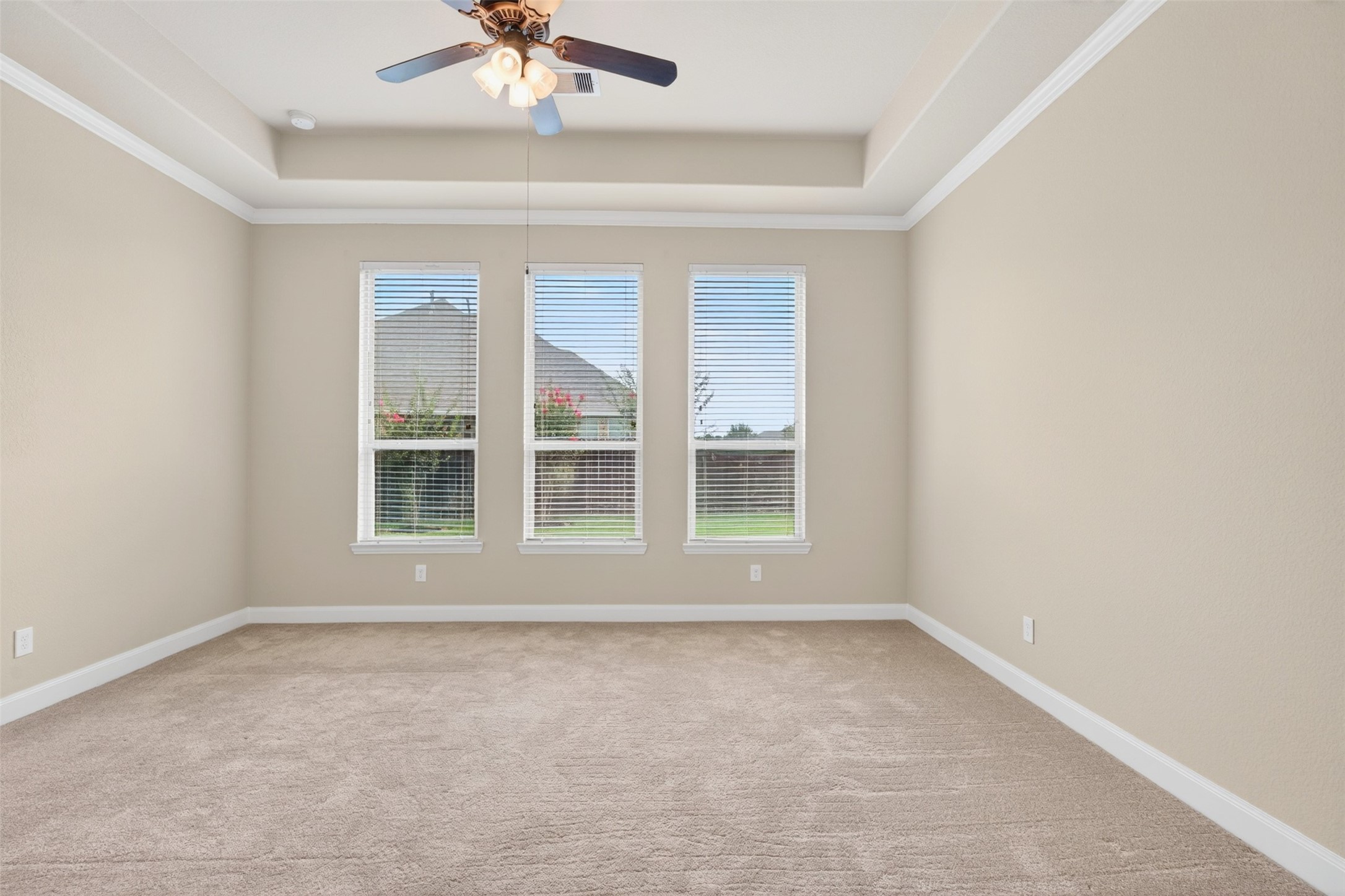 18202 Wedgewood Bluff Court Spring, TX 77379 - Photo 27 of 50 Primary bedroom window view with soft natural light and neutral carpet.