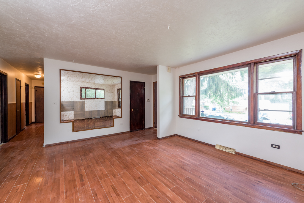 2030 Wright Avenue North Chicago, IL 60064 - Photo 3 of 10 a view of an empty room with a window and wooden floor