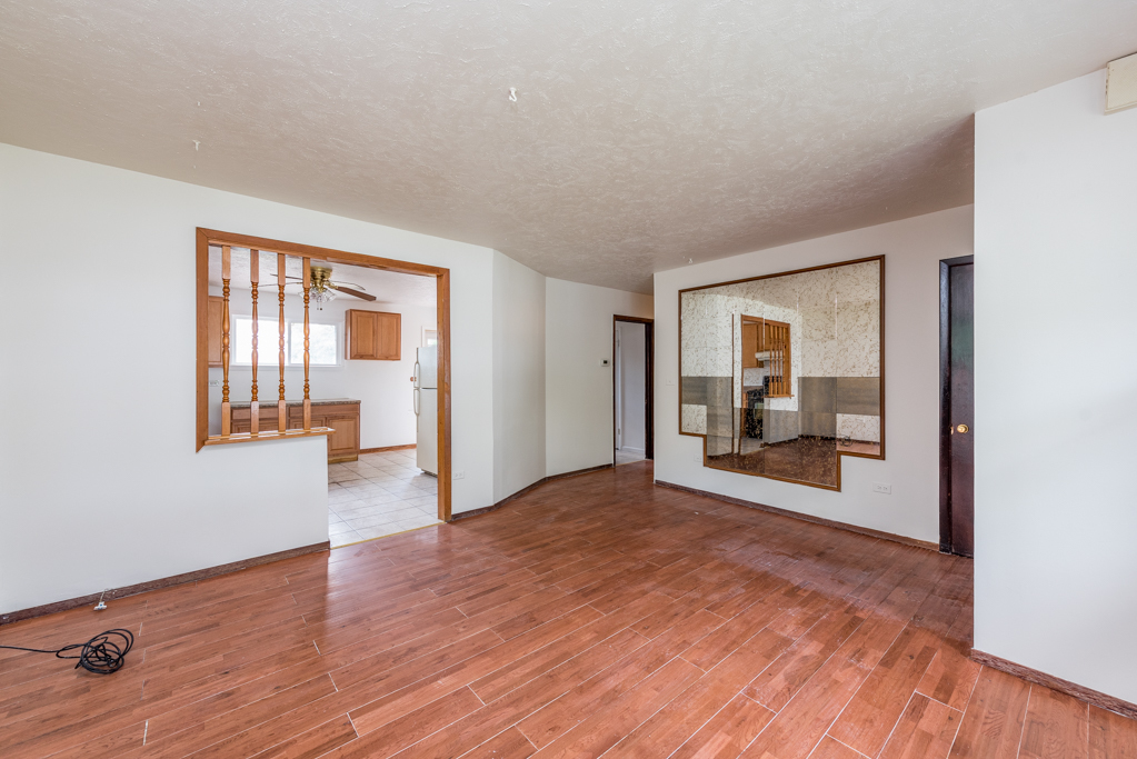 2030 Wright Avenue North Chicago, IL 60064 - Photo 4 of 10 a view of a room with wooden floor fireplace and windows