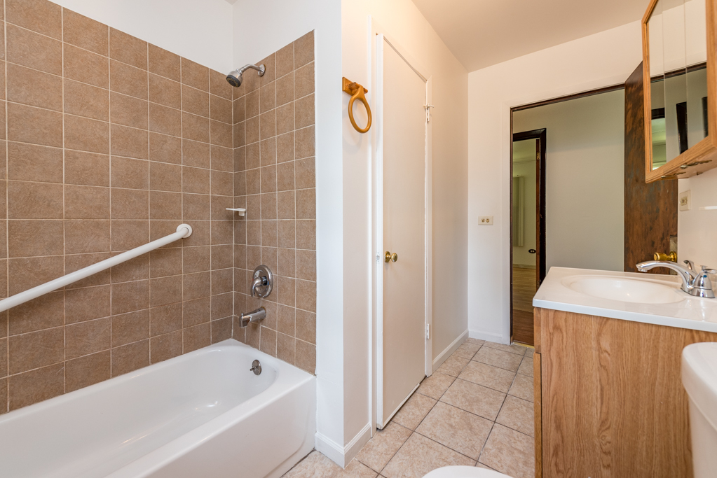 2030 Wright Avenue North Chicago, IL 60064 - Photo 6 of 10 a bathroom with a tub a sink and a shower