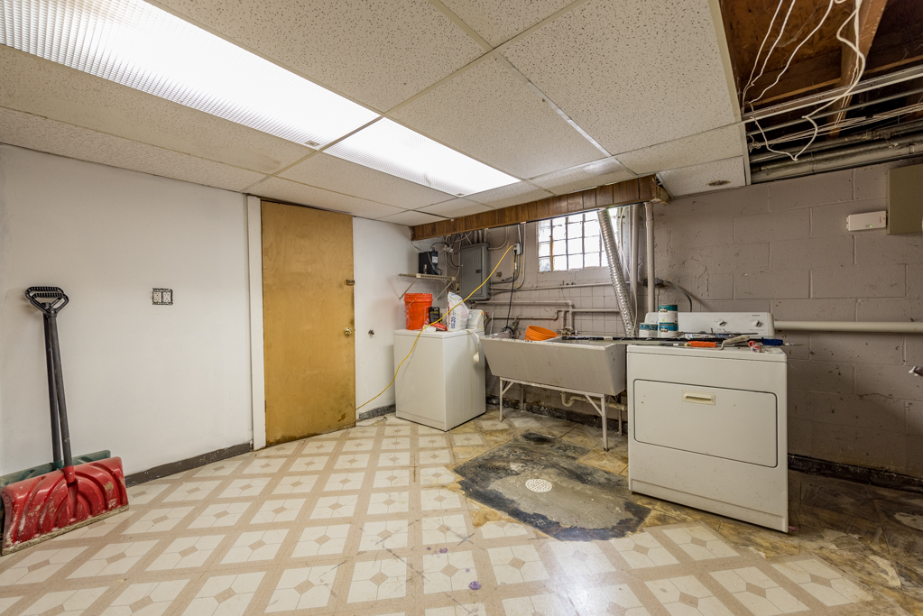 2030 Wright Avenue North Chicago, IL 60064 - Photo 9 of 10 a room with a chair and white cabinets