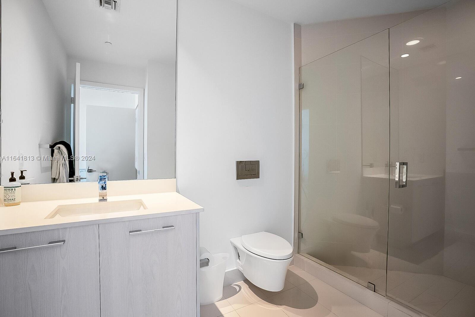 45 Southwest 9th Street, Unit 4403 Miami, FL 33130 - Photo 12 of 21 a bathroom with a toilet sink and shower