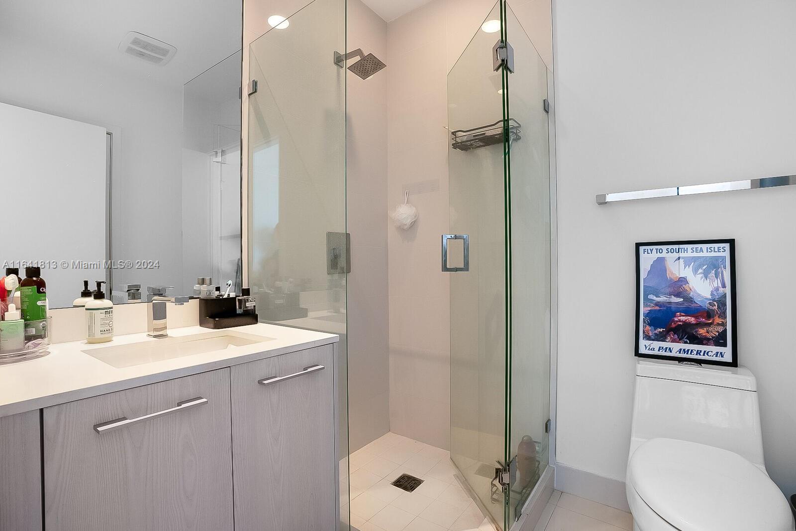 45 Southwest 9th Street, Unit 4403 Miami, FL 33130 - Photo 14 of 21 a bathroom with a sink a toilet and shower