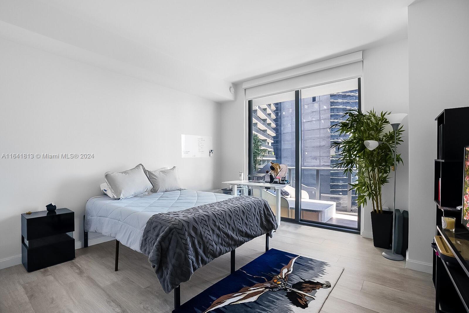 45 Southwest 9th Street, Unit 4403 Miami, FL 33130 - Photo 8 of 21 a bedroom with a bed and a flat screen television