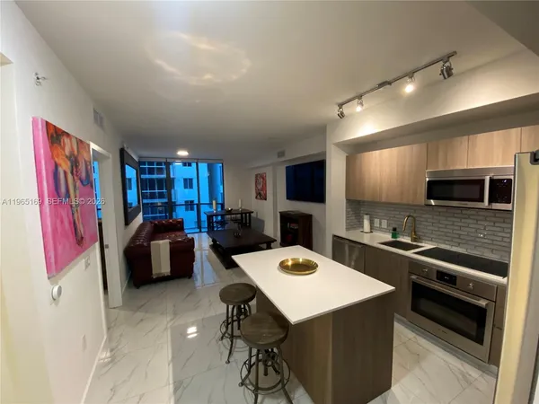 a kitchen that has a table and chairs in it