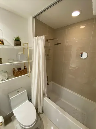 a bathroom with a toilet and a bathtub