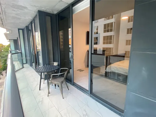 a view of living room kitchen with furniture and outdoor seating