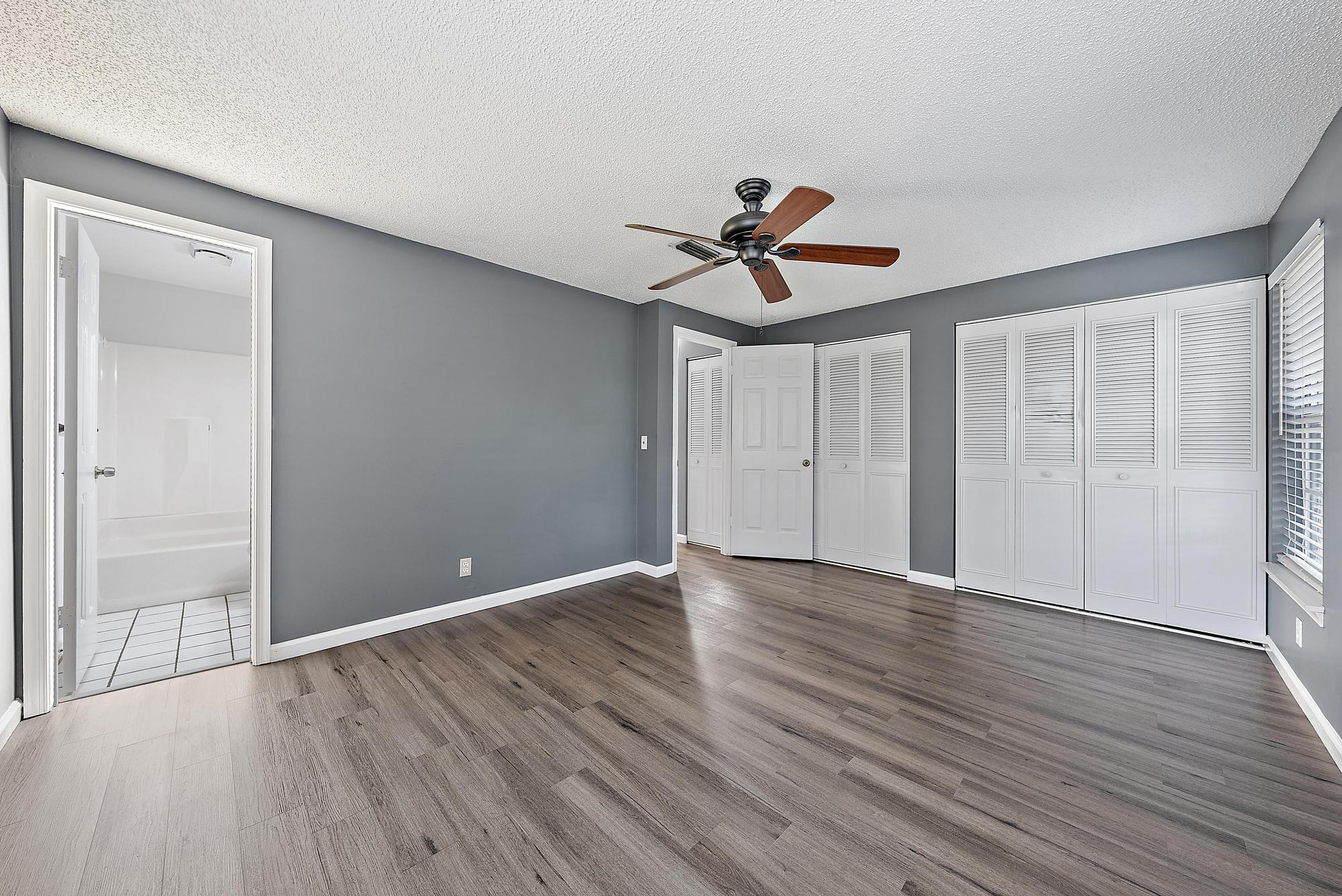 301 Georgian Park Drive Jupiter, FL 33458 - Photo 24 of 33 a view of room with wooden floor and ceiling fan