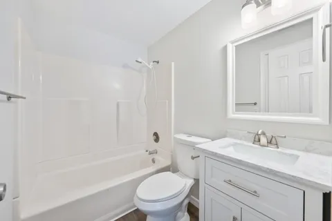 a bathroom with a sink a toilet and a bathtub