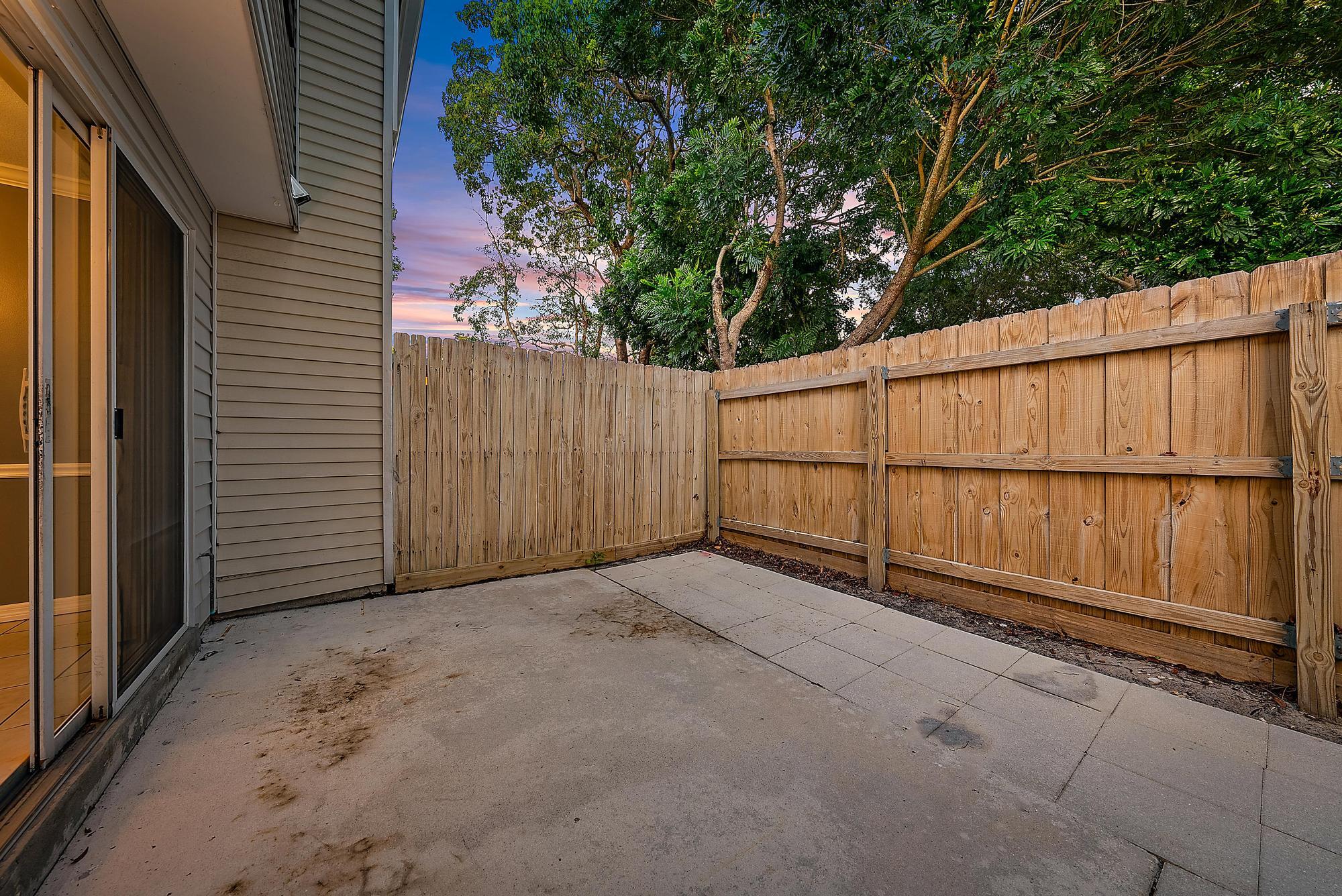 301 Georgian Park Drive Jupiter, FL 33458 - Photo 28 of 33 a view of backyard with wooden fence