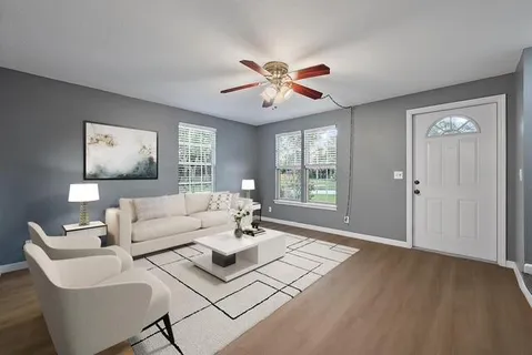 a living room with furniture and a large window