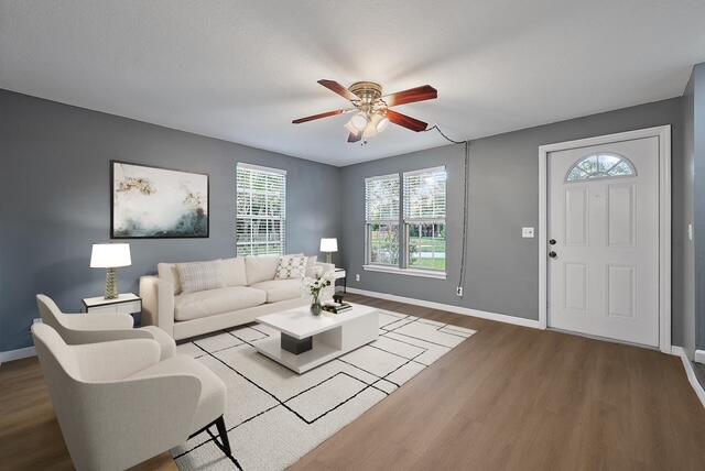 301 Georgian Park Drive Jupiter, FL 33458 - Photo 3 of 33 a living room with furniture and a large window