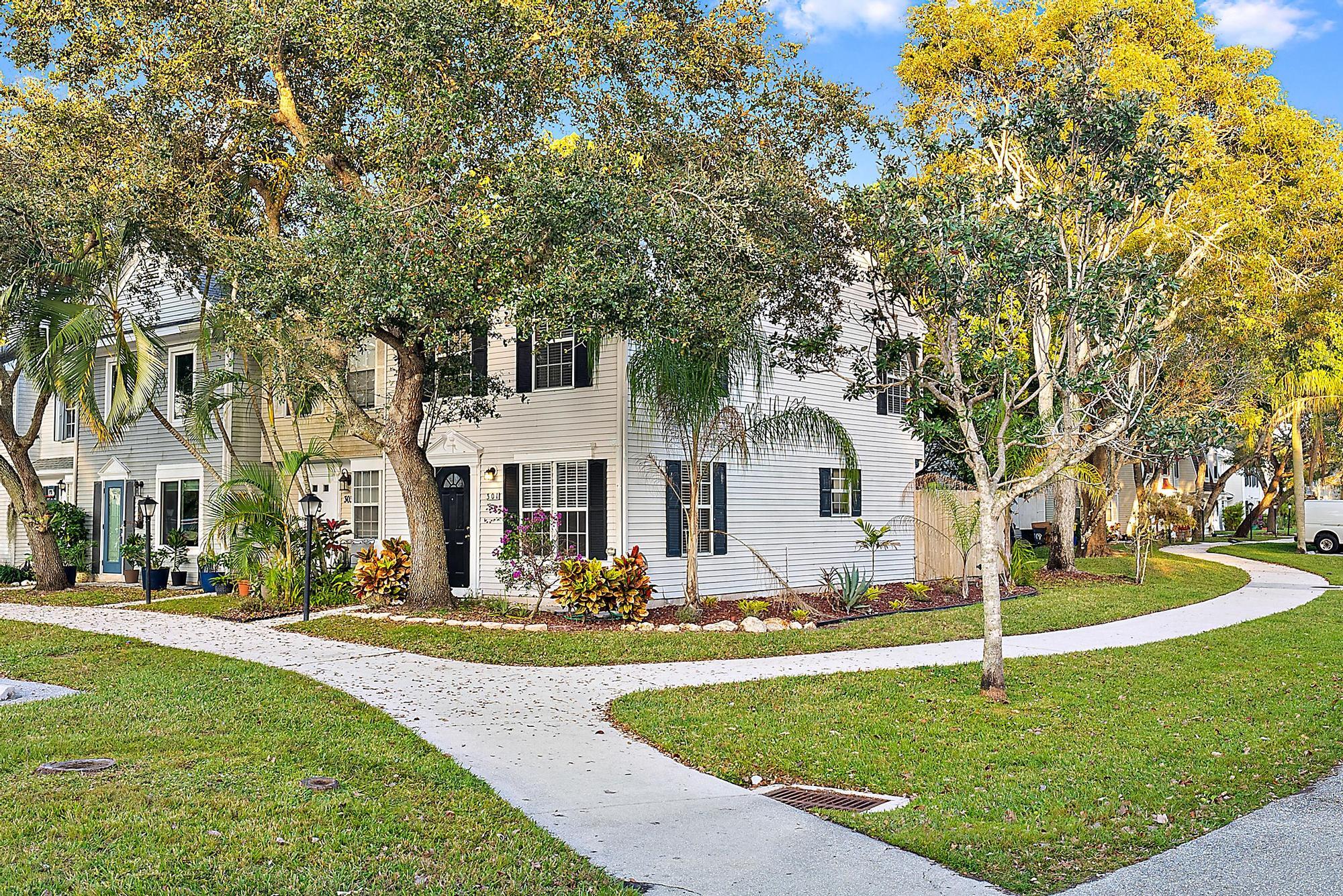 301 Georgian Park Drive Jupiter, FL 33458 - Photo 33 of 33 a front view of a house with a garden