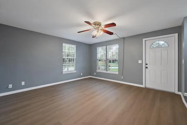 wooden floor in an empty room with a window