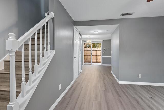 301 Georgian Park Drive Jupiter, FL 33458 - Photo 6 of 33 a view of a hallway with wooden floor and windows