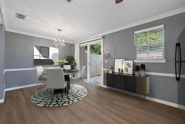 a living room with furniture a dining table wooden floor and a fireplace