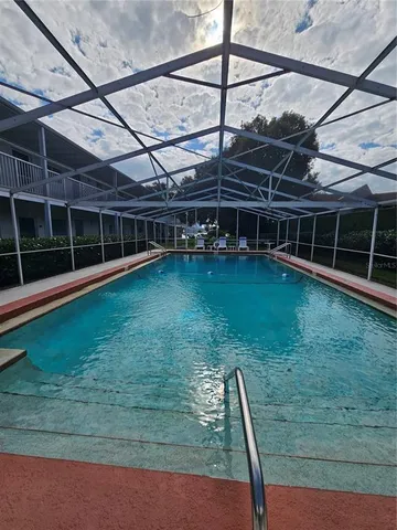 a view of a backyard with plants and wooden fence