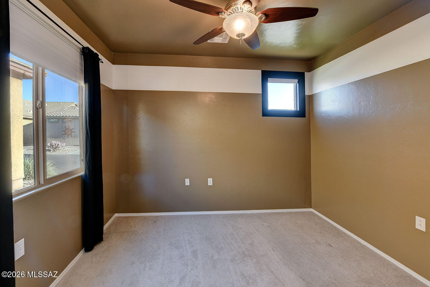 13991 East Cheavront Loop Vail, AZ 85641 - Photo 23 of 47 an empty room with a ceiling fan and a window