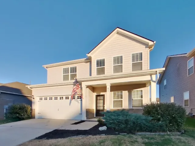 a view of a brick house with windows and yard